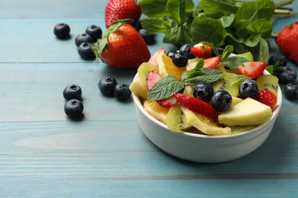 Tasty Fruit Salad Bowl Ingredients Light Blue Wooden Table Closeup — Stock Photo, Image