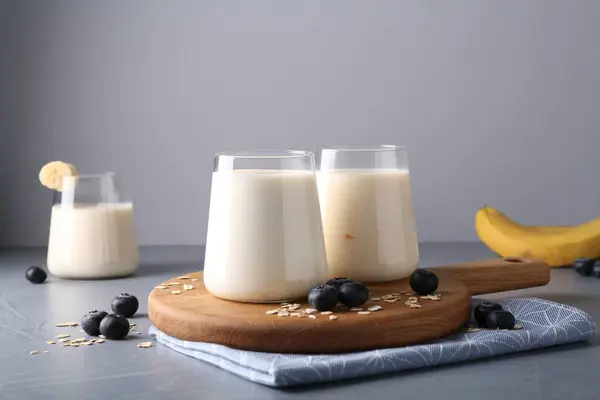 Tasty Yogurt Glasses Oats Blueberries Grey Table — Stock Photo, Image
