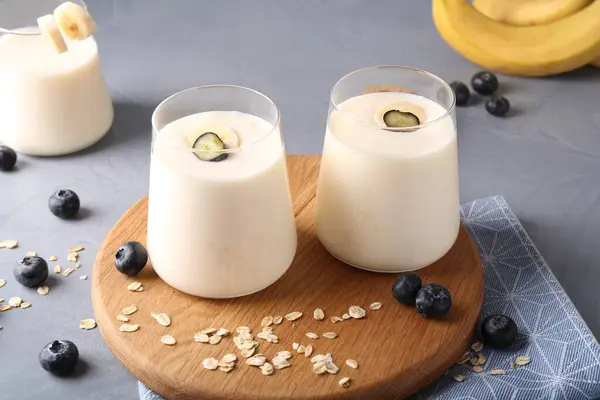 Tasty Yogurt Glasses Oats Blueberries Grey Table — Stock Photo, Image