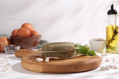 Vejetaryen ürünü. Pişmemiş fasulye pirzolası ve malzemeler beyaz ahşap masada.