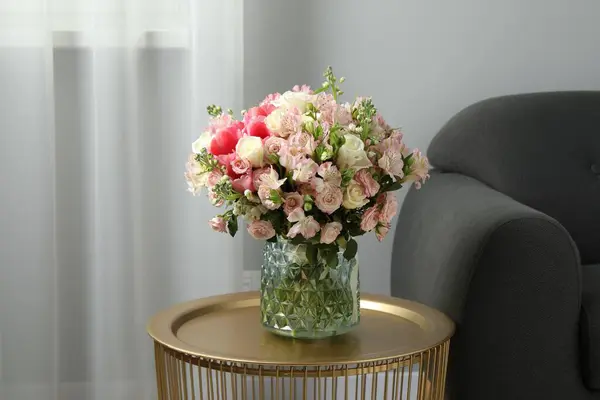 Beautiful bouquet of fresh flowers on coffee table in room, space for text