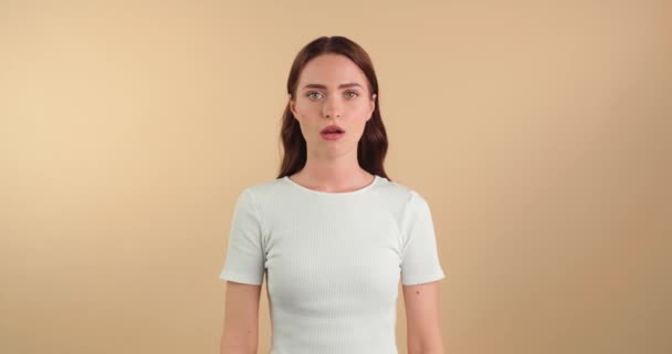 Displeased Young Woman Crossing Arms Beige Background — Stock Video