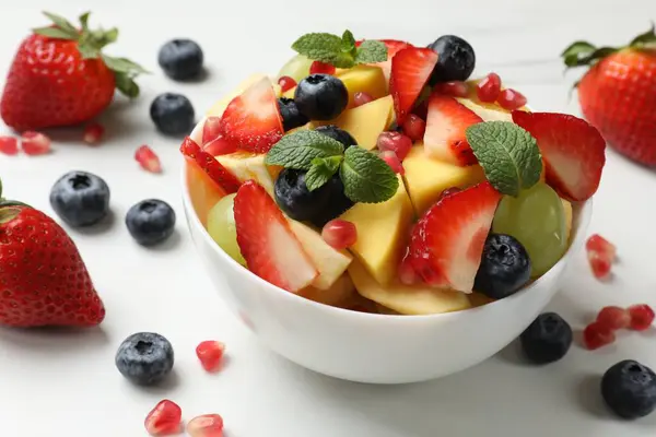 Salada Frutas Saborosas Tigela Ingredientes Mesa Branca Close — Fotografia de Stock