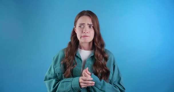 Concerned Woman Wringing Her Hands Light Blue Background — Stock Video