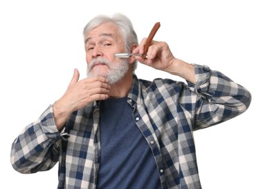 Yaşlı adam, beyaz arka planda bıçak ile sakal tıraşı oluyor.