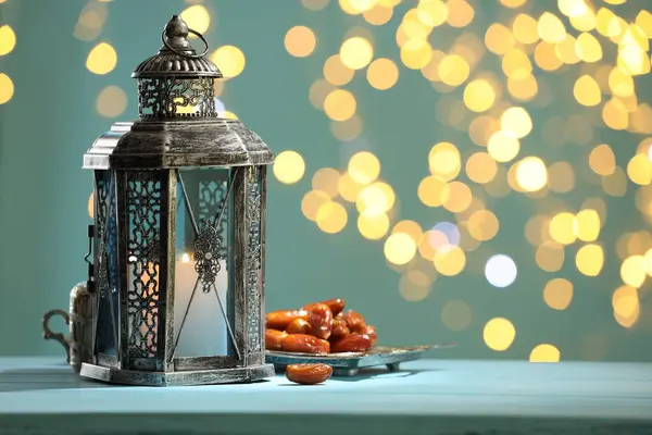 stock image Traditional Arabic lantern and dates on table against blurred lights. Space for text