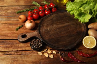 Yemek pişiriyorum. Tahta kesmek ve tuğla duvarın yanındaki ahşap masada farklı ürünler.