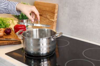 Mutfakta yemek pişiren kadın, yakın plan.