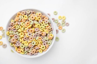 Beyaz masadaki kasede leziz mısır gevreği halkaları, üst manzara. Metin için boşluk