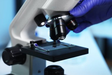 Modern mikroskop ile çalışan bilim adamı kapalı alanda, yakın çekim