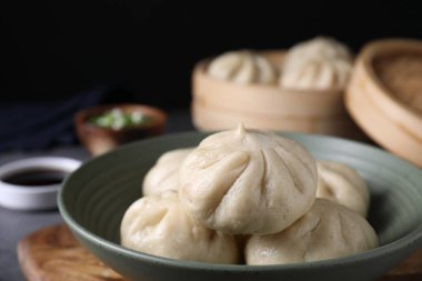 Lezzetli çörekler (baozi) gri masada, yakın plan.