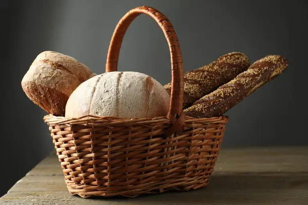 Wicker Basket Different Types Fresh Bread Wooden Table — Stock Photo, Image