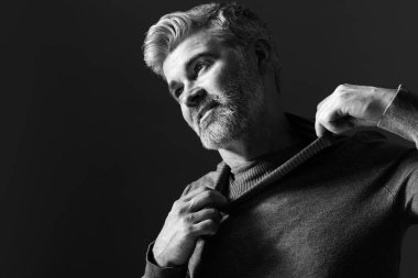 Koyu arkaplanda yakışıklı bir adamın portresi, mesaj için boşluk. Siyah ve beyaz etkisi