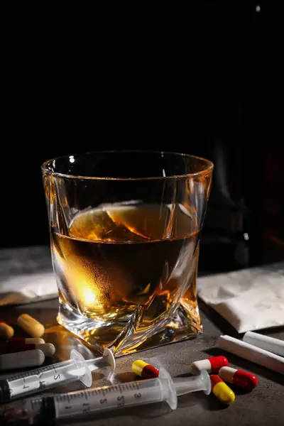Alcohol Drug Addiction Whiskey Glass Syringes Pills Cocaine Grey Table Stockbild
