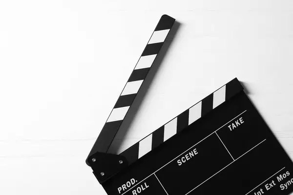 stock image Clapperboard on white wooden table, top view. Space for text