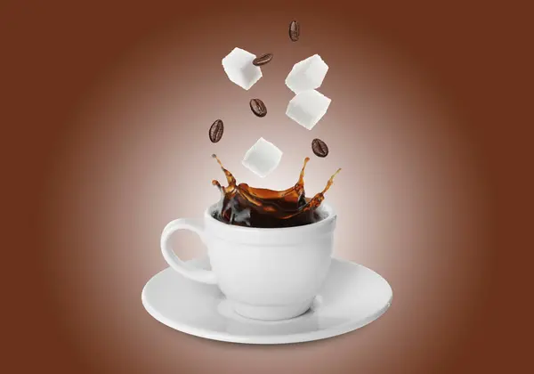Coffee splashing in cup due to falling roasted beans and sugar cubes on brown gradient background