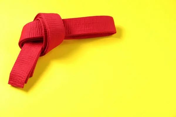 Red Karate Belt Yellow Background Top View Space Text — Stock Photo, Image