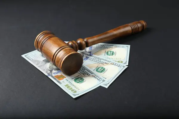 stock image Law gavel with dollars on grey table