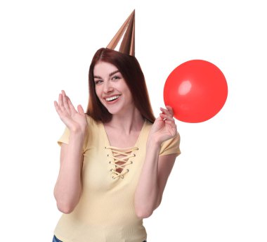 Beyaz arka planda balonu olan parti şapkalı mutlu kadın.