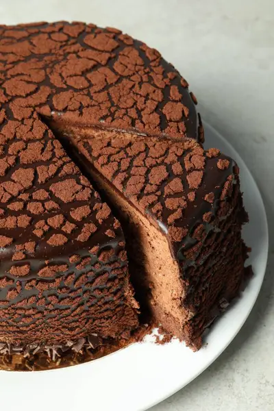 Delicious chocolate truffle cake on grey table