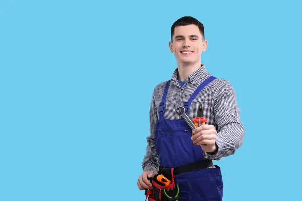Young Man Holding Pliers Light Blue Background Space Text — Stock Photo, Image