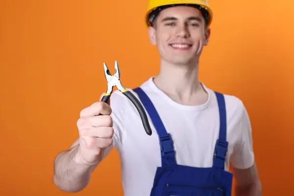 Young Man Holding Pliers Orange Background Selective Focus — Stock Photo, Image
