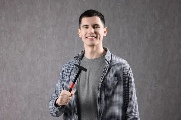 Young Man Holding Hammer Grey Background — Stock Photo, Image