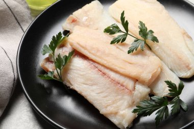 Çiğ balık ve maydanozlu tabak, yakın plan.