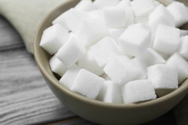 Tahta masada kasede beyaz şeker küpleri, yakın plan.