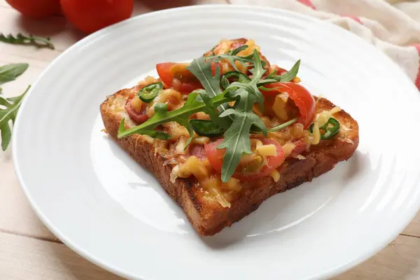 Tasty pizza toast on light wooden table