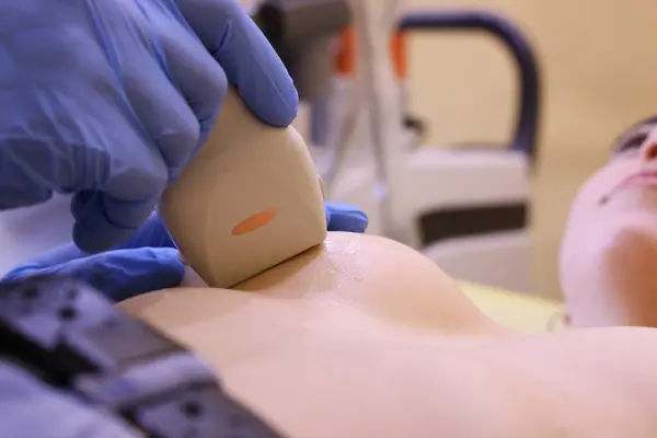 stock image Mammologist conducting ultrasound examination of woman's breast in clinic, closeup