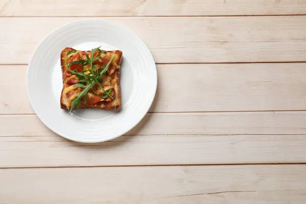 Tasty pizza toast on light wooden table, top view. Space for text