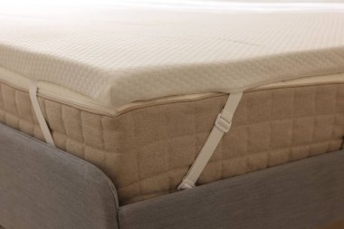 Gri yatakta beyaz, köpüklü yatak üstü, yakın plan.