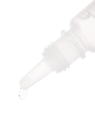 Beyaz arka planda şişeden damlayan tıbbi damlalar