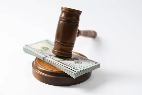 stock image Law gavel with stack of dollars on white background