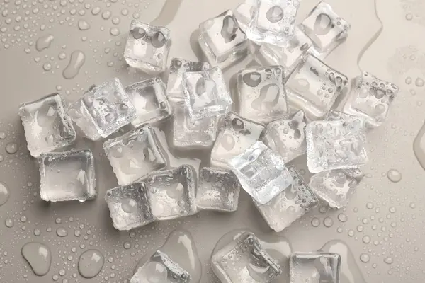 Melting Ice Cubes Water Drops Light Grey Background Flat Lay Royalty Free Stock Photos