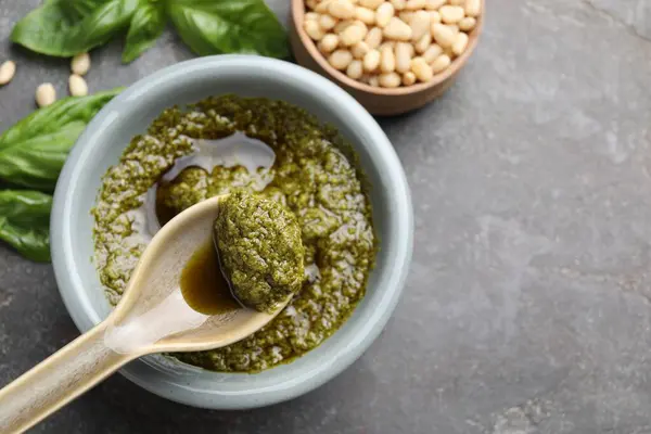 Taking Tasty Pesto Sauce Grey Table Top View Space Text 图库照片