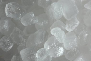 White natural salt as background, closeup view clipart