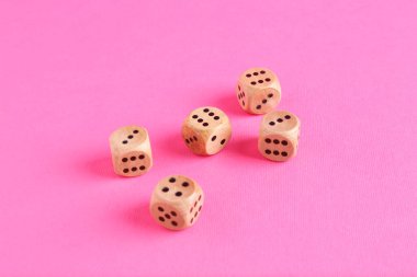 Pembe arka planda pek çok tahta oyun zarı