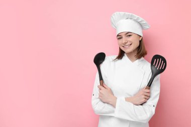 Professional chef with skimmer and ladle on pink background. Space for text