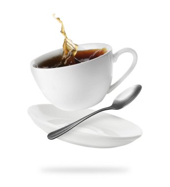 Cup of coffee, saucer and spoon in air on white background