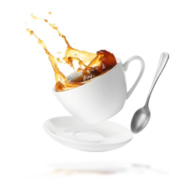 Cup of coffee, saucer and spoon in air on white background