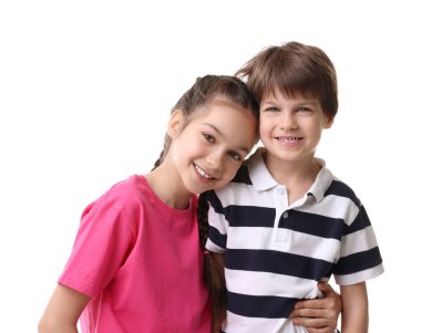 Mutlu erkek ve kız kardeşler beyaz arka planda sarılıyorlar.