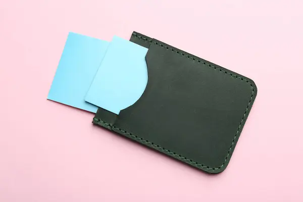 Stock image Leather business card holder with blank cards on pink background, top view