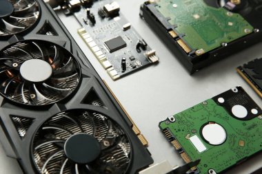 Graphics card and other computer hardware on gray background, closeup