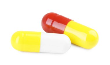 Beyaza izole edilmiş iki antibiyotik hapı. Tıbbi tedavi