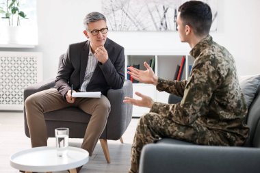 Professional psychotherapist working with military man in office