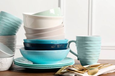 Güzel seramik bulaşık takımı, bardak ve çatal bıçak takımı ahşap masada.