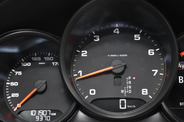 Speedometer and tachometer inside of modern car, closeup