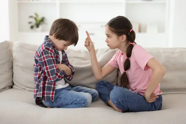 stock image Upset brother and sister having argument on sofa at home